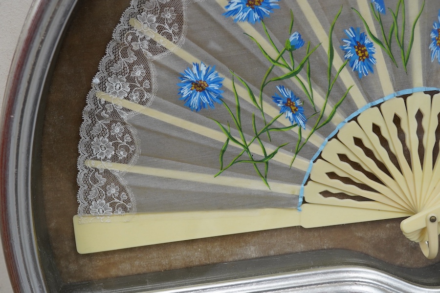 A 20th century silver painted fan case housing a hand painted floral and machine lace fan, case 40cm wide at base. Condition - fan good, case good